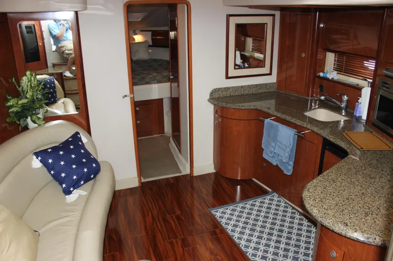  Yacht Photos Pics Interior of 2005 Sea Ray 420 Sundancer yacht with kitchen and seating area.
