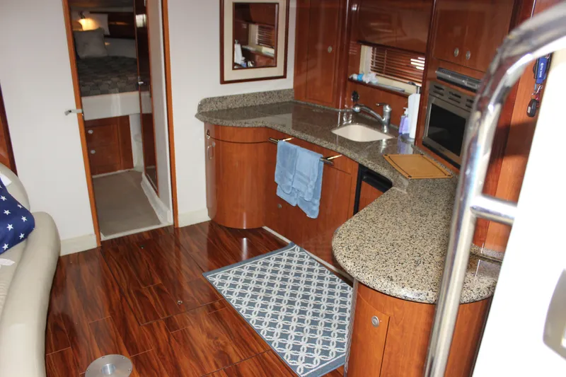  Yacht Photos Pics Luxurious 2005 Sea Ray 420 Sundancer yacht interior with modern kitchen and wood flooring.