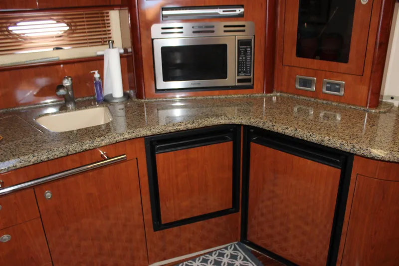  Yacht Photos Pics Luxurious kitchen interior of 2005 Sea Ray 420 Sundancer with granite countertops and modern appliances.