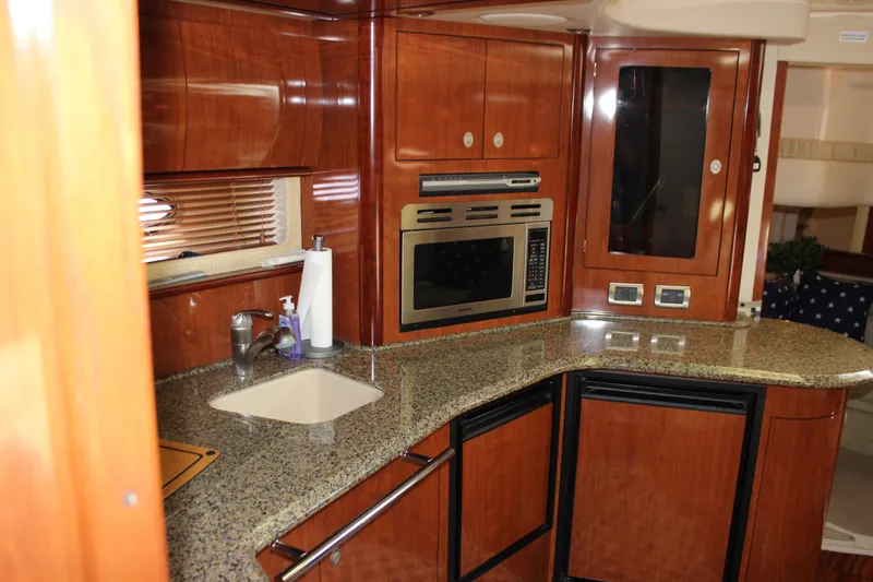  Yacht Photos Pics Luxurious 2005 Sea Ray 420 Sundancer yacht kitchen with wood cabinetry and modern appliances.
