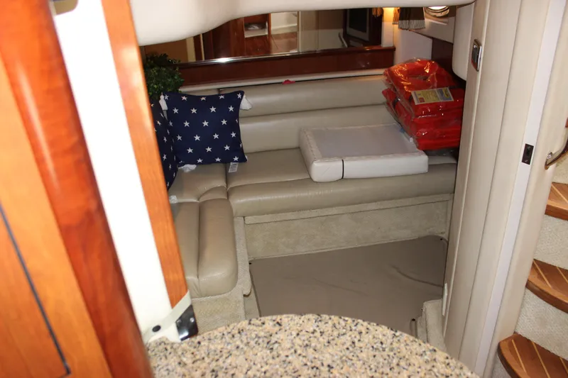  Yacht Photos Pics Interior of 2005 Sea Ray 420 Sundancer yacht with beige seating and star-patterned pillow.