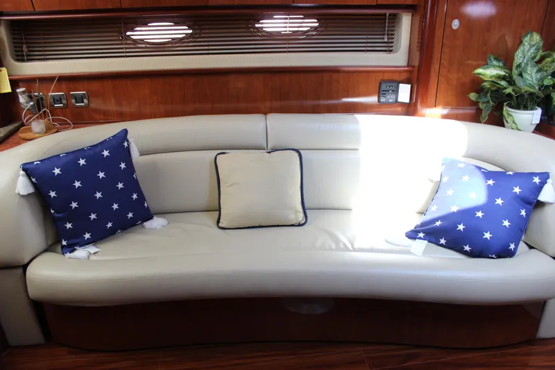  Yacht Photos Pics Interior of 2005 Sea Ray 420 Sundancer with cream leather sofa and star-patterned cushions.