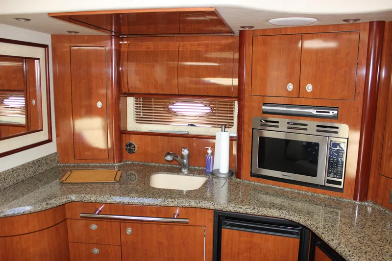  Yacht Photos Pics Luxurious 2005 Sea Ray 420 Sundancer yacht kitchen with wood cabinetry and modern appliances.