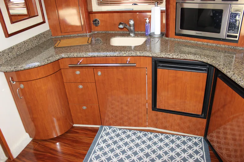  Yacht Photos Pics Luxurious 2005 Sea Ray 420 Sundancer yacht kitchen with granite countertops and wood cabinetry.