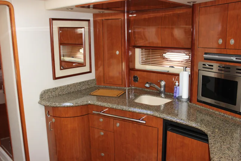  Yacht Photos Pics Luxurious 2005 Sea Ray 420 Sundancer yacht kitchen with wood cabinetry and granite countertops.