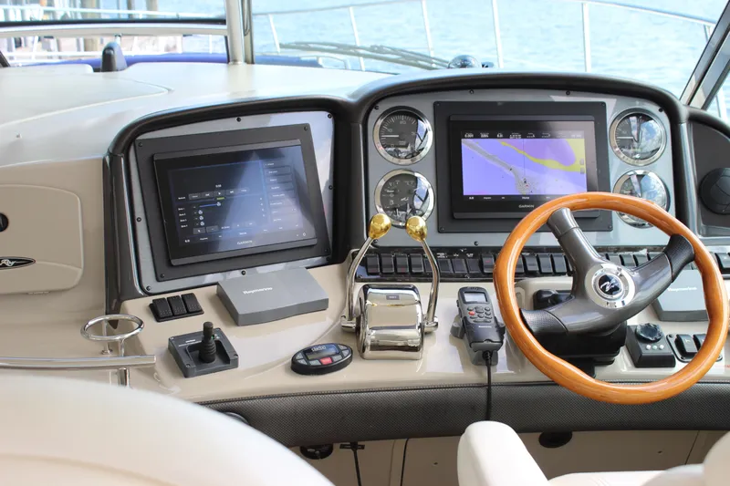  Yacht Photos Pics Helm of 2005 Sea Ray 420 Sundancer with navigation screens and wooden steering wheel.