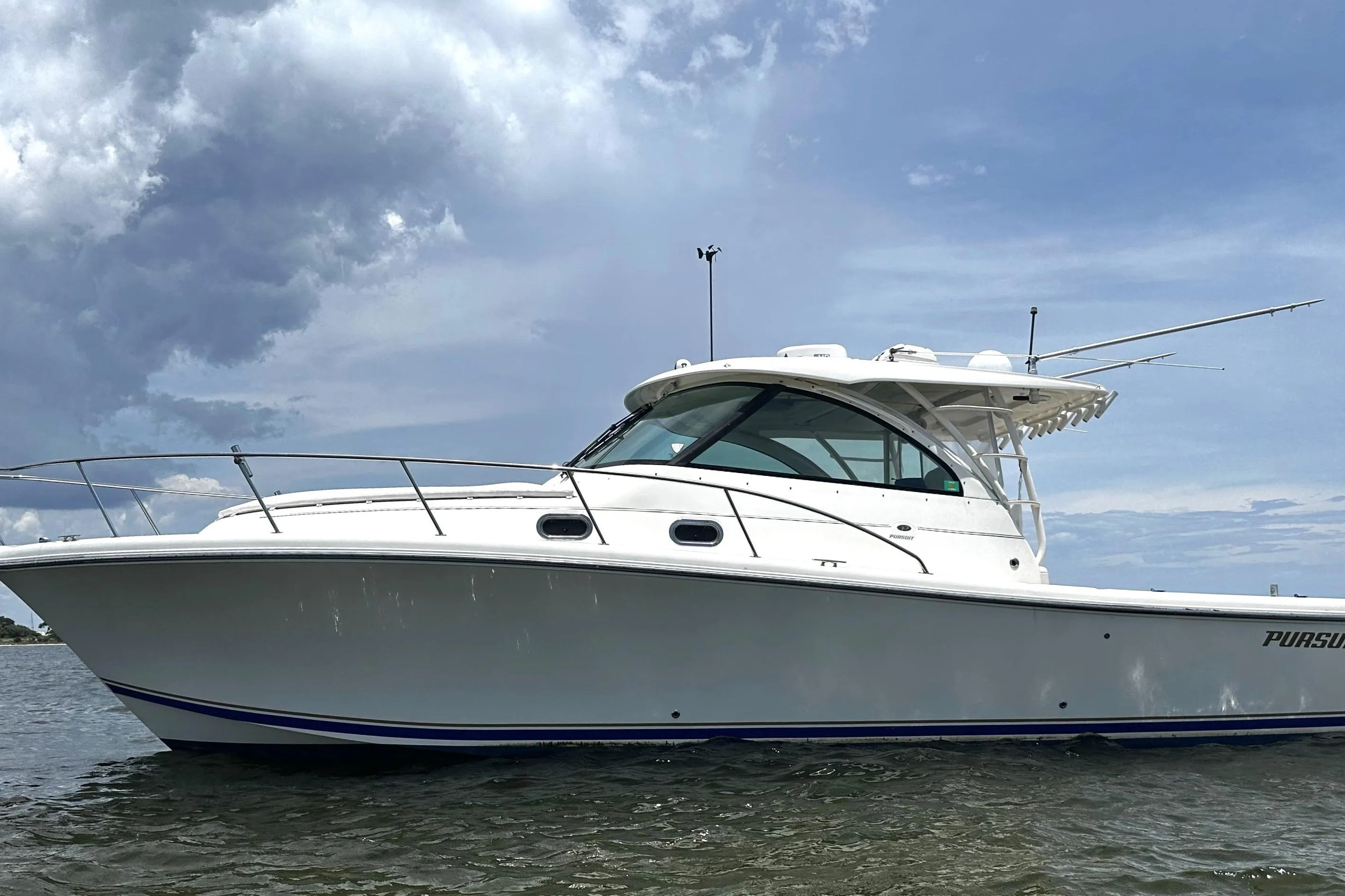 2013 Pursuit OS 385 Offshore boat on water under cloudy sky.