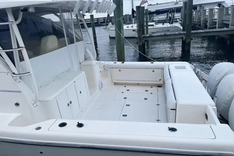  Yacht Photos Pics 2013 Pursuit OS 385 Offshore boat docked, featuring spacious deck and seating area.