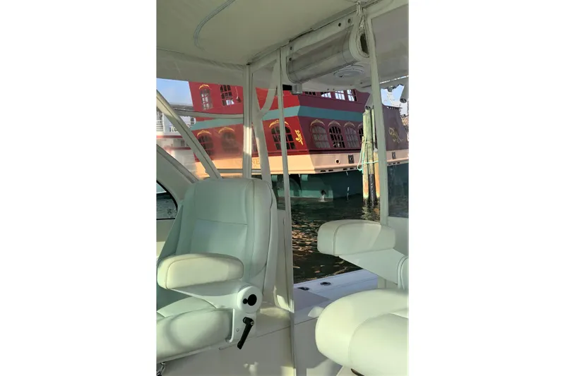  Yacht Photos Pics Interior view of 2013 Pursuit OS 385 Offshore boat with waterfront backdrop.
