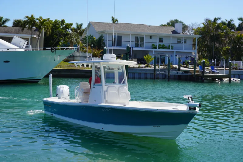  Yacht Photos Pics 2024 Regulator 26XO boat cruising in a sunny waterfront setting.