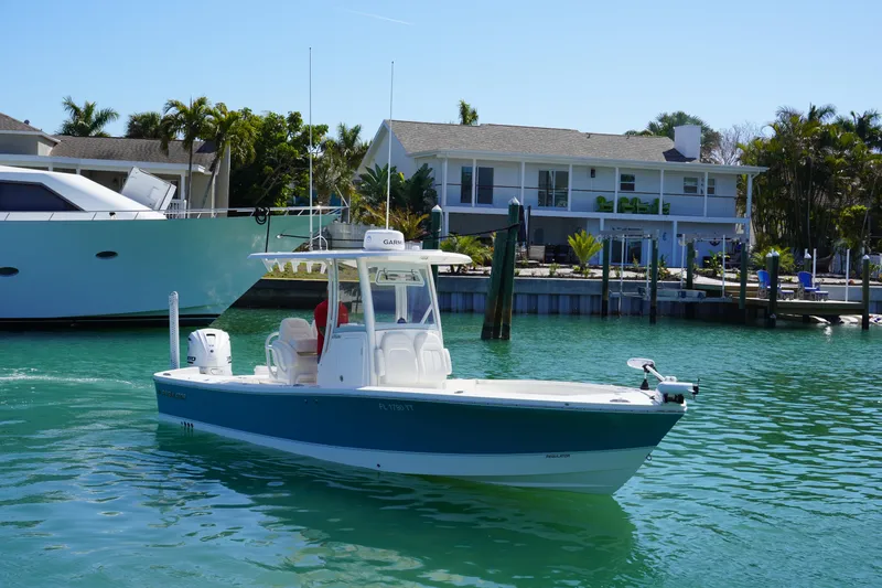  Yacht Photos Pics 2024 Regulator 26XO boat cruising in a sunny waterfront setting.