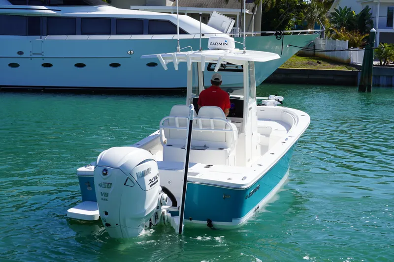  Yacht Photos Pics 2024 Regulator 26XO boat with Yamaha 450 V8 engine on turquoise water.