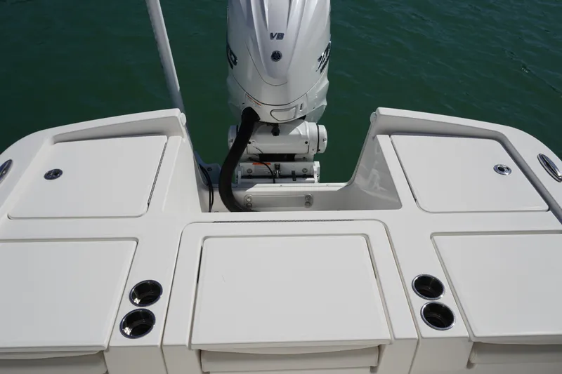  Yacht Photos Pics 2024 Regulator 26XO boat stern with outboard motor and storage compartments.