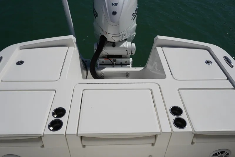  Yacht Photos Pics 2024 Regulator 26XO boat stern with outboard motor and storage compartments.