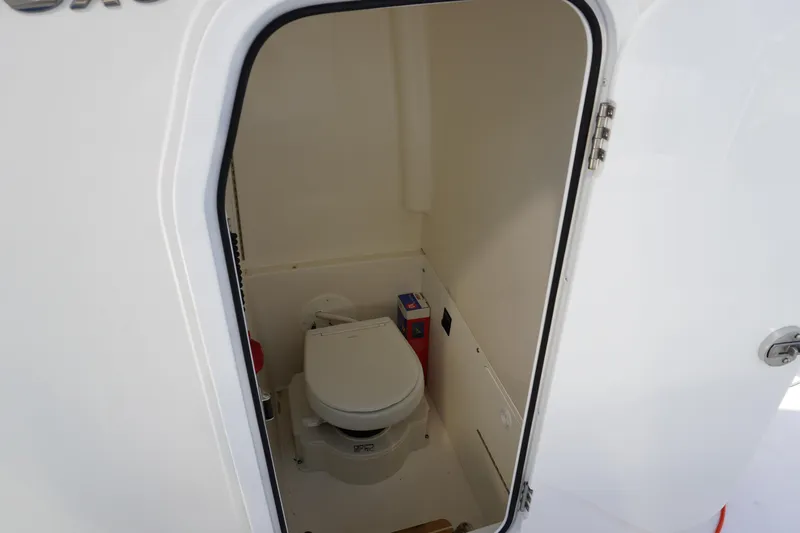  Yacht Photos Pics 2024 Regulator 26XO boat interior with compact marine toilet.