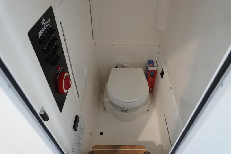  Yacht Photos Pics 2024 Regulator 26XO boat interior with toilet and control panel.