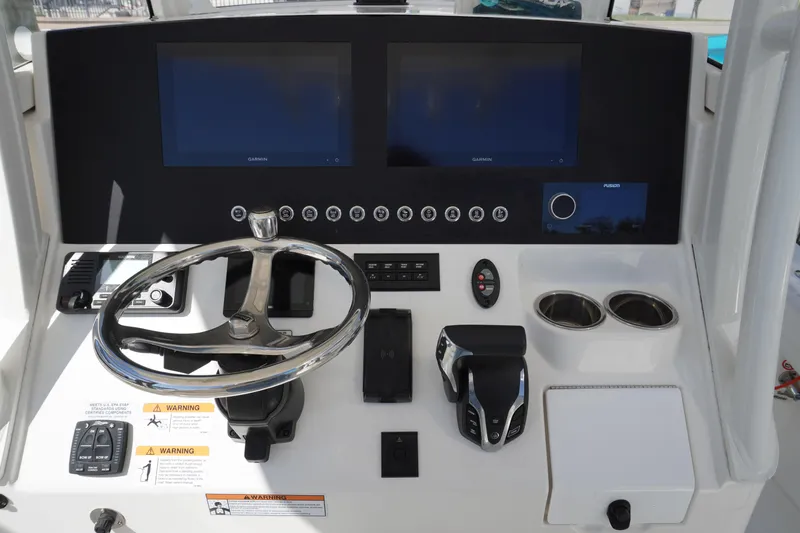  Yacht Photos Pics 2024 Regulator 26XO boat dashboard with dual screens and steering wheel.