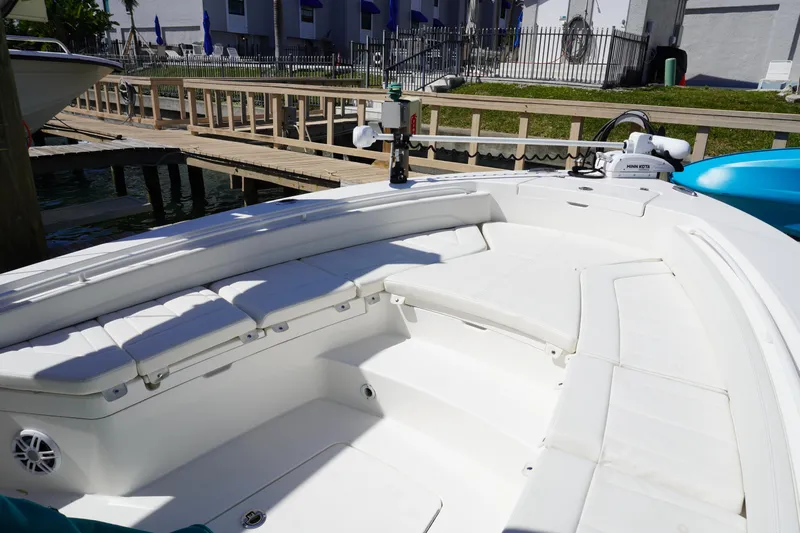  Yacht Photos Pics 2024 Regulator 26XO boat interior with white seating and dockside view.