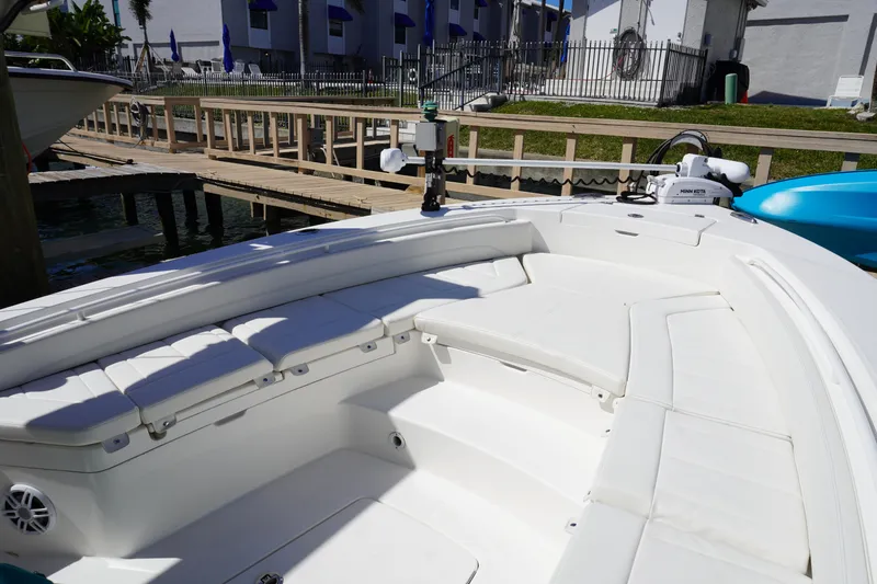  Yacht Photos Pics 2024 Regulator 26XO boat interior with white seating and dockside view.