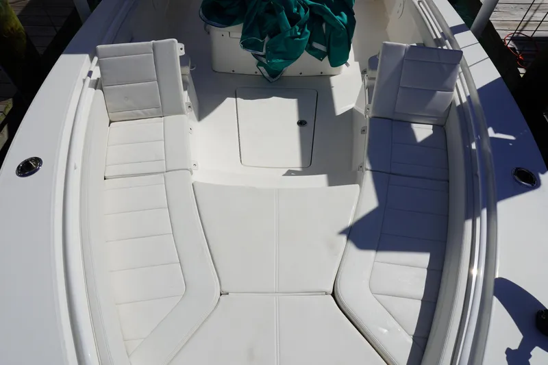  Yacht Photos Pics 2024 Regulator 26XO boat interior with white cushioned seating and teal cover.