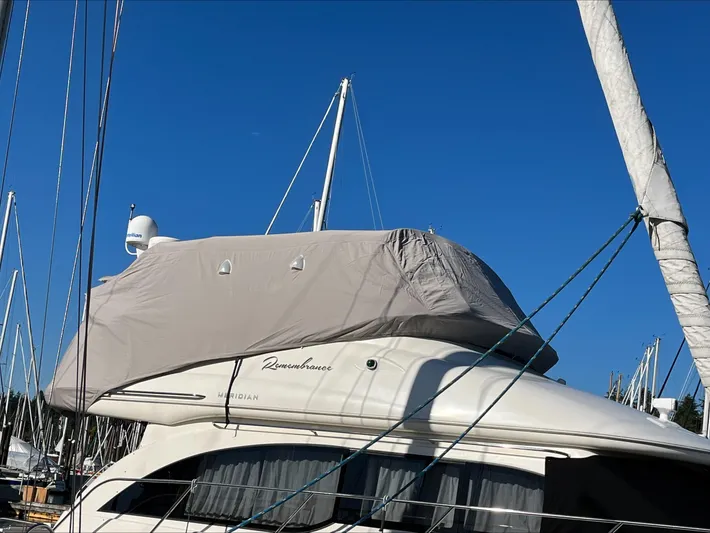 Remembrance Yacht Photos Pics 2006 Meridian 411 Sedan yacht covered, docked in marina under clear blue sky.