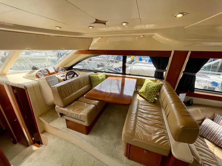 Remembrance Yacht Photos Pics Luxurious interior of a 2006 Meridian 411 Sedan yacht with leather seating and wood accents.