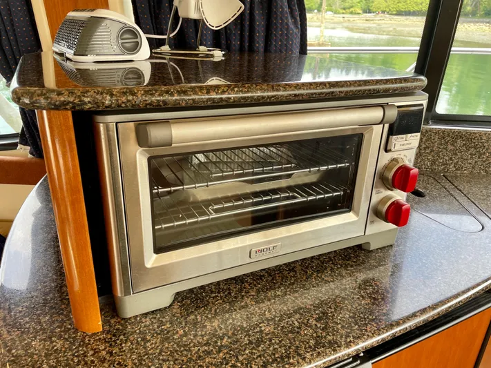 Remembrance Yacht Photos Pics Toaster oven on granite countertop inside 2006 Meridian 411 Sedan yacht kitchen.