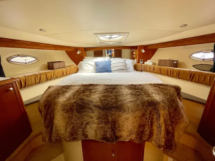 Remembrance Yacht Photos Pics Luxurious bedroom interior of 2006 Meridian 411 Sedan yacht with plush bedding and elegant wood accents.