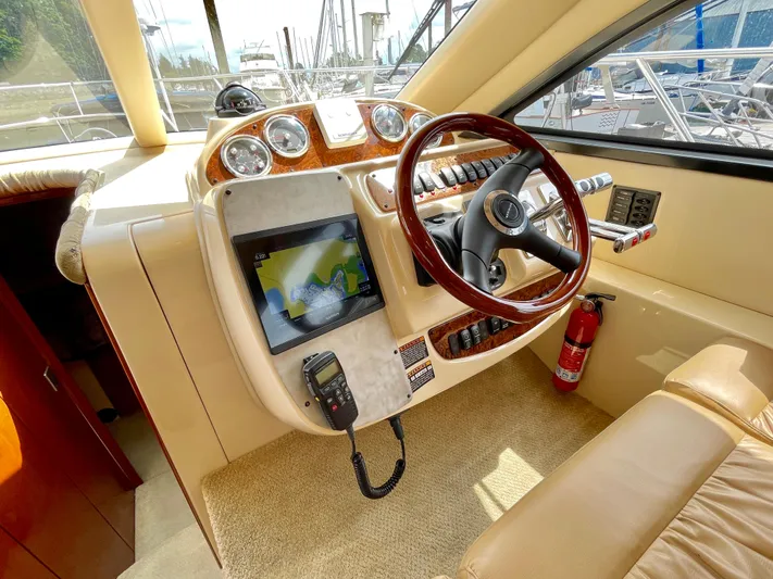 Remembrance Yacht Photos Pics Interior of 2006 Meridian 411 Sedan yacht with steering wheel and navigation system.