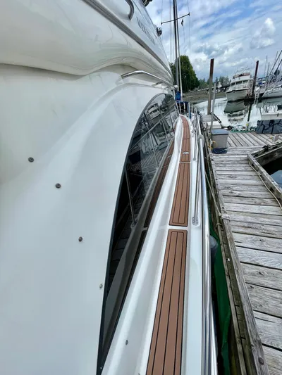 Remembrance Yacht Photos Pics Side view of a 2006 Meridian 411 Sedan yacht docked at a marina.