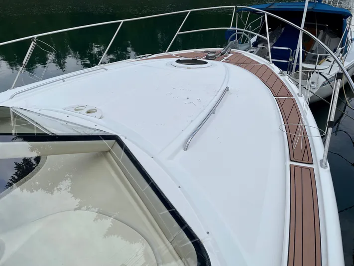 Remembrance Yacht Photos Pics 2006 Meridian 411 Sedan yacht deck with wooden accents, docked on calm water.