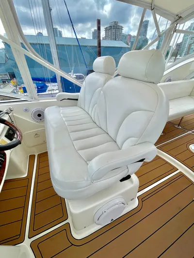 Remembrance Yacht Photos Pics Luxurious white seating on 2006 Meridian 411 Sedan yacht, featuring elegant wood flooring.