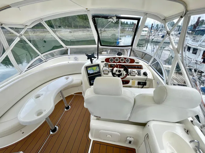 Remembrance Yacht Photos Pics 2006 Meridian 411 Sedan helm with white seating, wood accents, and marina view.