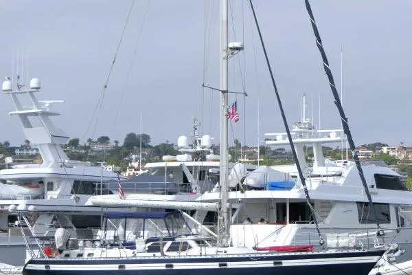 Majestic Yacht Photos Pics 2006 Tayana 58 Deck Salon yacht docked in a marina with other boats.