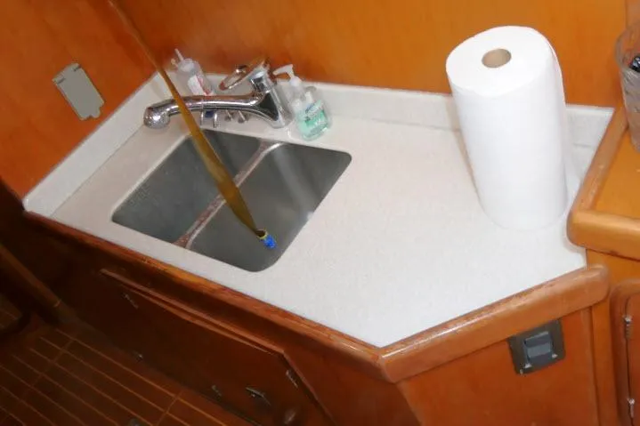 Majestic Yacht Photos Pics Sink area in 2006 Tayana 58 Deck Salon yacht with faucet and paper towel.