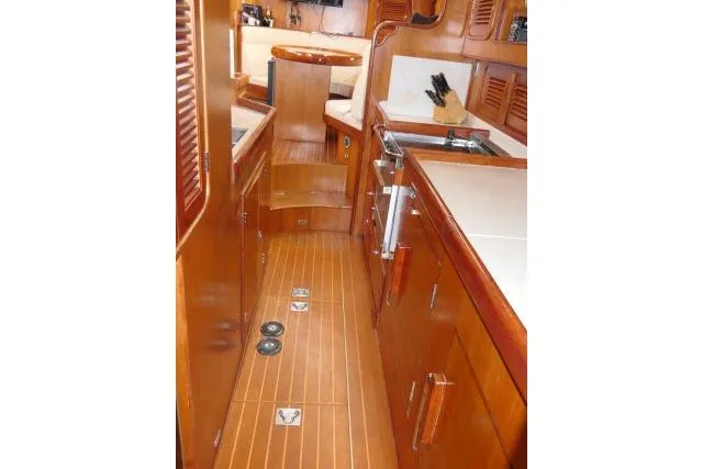 Majestic Yacht Photos Pics Interior of 2006 Tayana 58 Deck Salon yacht with wooden cabinetry and flooring.