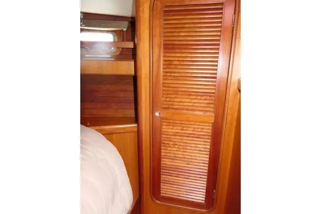 Majestic Yacht Photos Pics Interior of 2006 Tayana 58 Deck Salon with wooden cabinetry and louvered door.