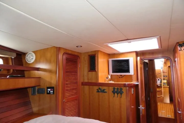 Majestic Yacht Photos Pics Interior of 2006 Tayana 58 Deck Salon yacht with wood paneling and TV.