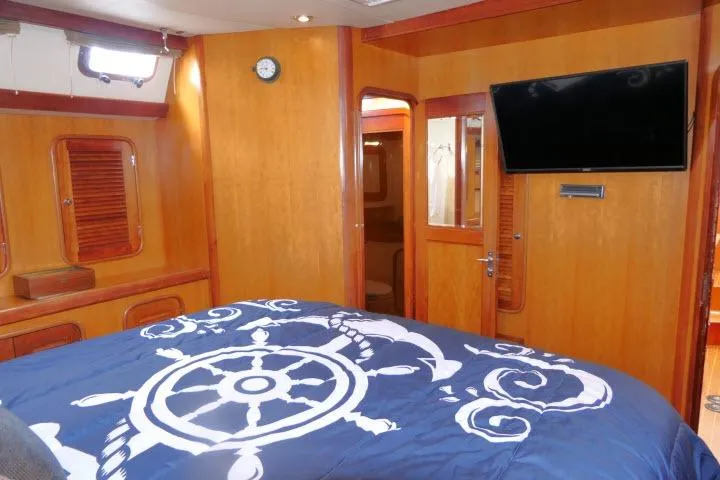 Majestic Yacht Photos Pics Luxurious 2006 Tayana 58 Deck Salon interior with nautical-themed bedding and modern amenities.