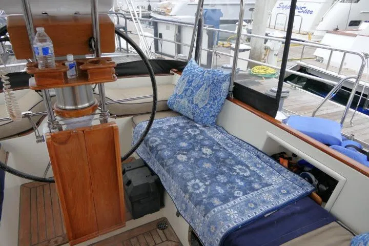 Majestic Yacht Photos Pics Cozy seating area on 2006 Tayana 58 Deck Salon yacht with blue cushions and wooden accents.