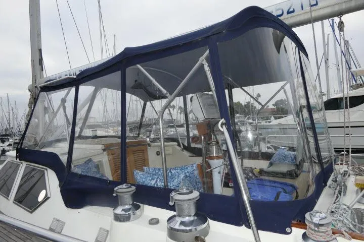 Majestic Yacht Photos Pics 2006 Tayana 58 Deck Salon sailboat with blue canopy in marina setting.