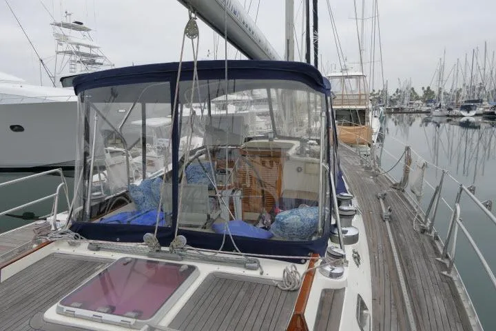 Majestic Yacht Photos Pics 2006 Tayana 58 Deck Salon yacht docked at marina, featuring spacious deck and clear canopy.
