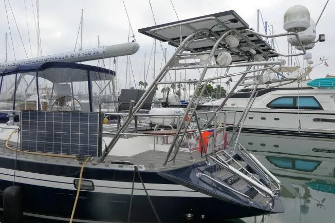Majestic Yacht Photos Pics 2006 Tayana 58 Deck Salon yacht with solar panels docked in marina.
