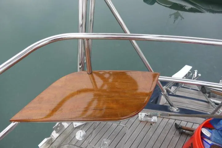 Majestic Yacht Photos Pics Polished wooden seat on 2006 Tayana 58 Deck Salon yacht, surrounded by stainless steel railings.