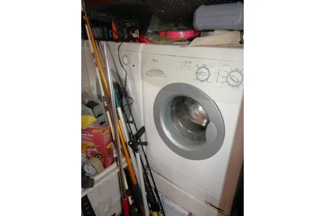 Majestic Yacht Photos Pics Laundry area with washing machine and fishing gear on Tayana 58 Deck Salon, 2006 model.
