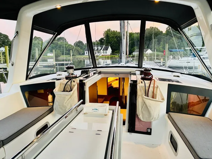  Yacht Photos Pics 2017 Beneteau Oceanis 45 yacht cockpit with seating, winches, and cabin entrance at marina.