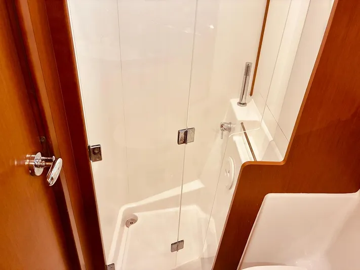  Yacht Photos Pics Shower area in 2017 Beneteau Oceanis 45 yacht, featuring sleek glass door and modern fixtures.