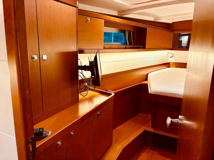  Yacht Photos Pics 2017 Beneteau Oceanis 45 interior cabin with wood finish and cozy bed.