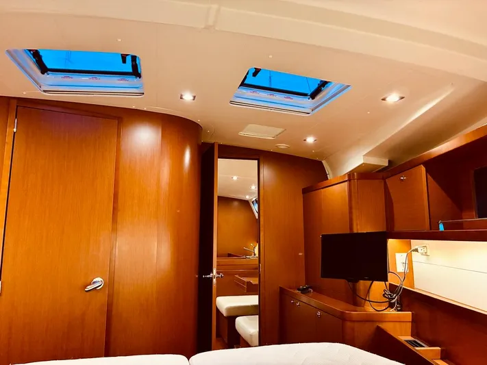  Yacht Photos Pics Interior of 2017 Beneteau Oceanis 45 yacht with wood finish and skylights.