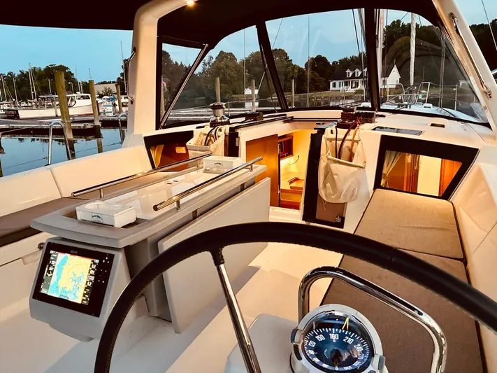  Yacht Photos Pics Interior view of 2017 Beneteau Oceanis 45 sailboat cockpit with navigation equipment.